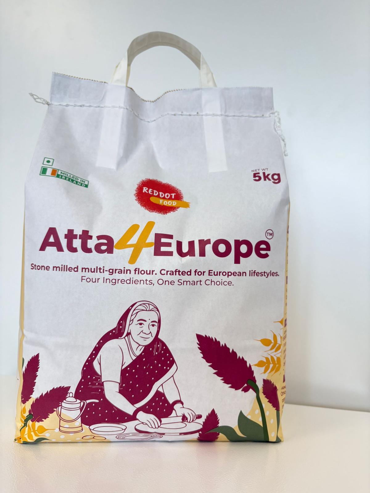 Pack of Reddot Food Multigrain Flour with ingredients like whole wheat, oats, Amaranth and Horsegram on a wooden kitchen surface